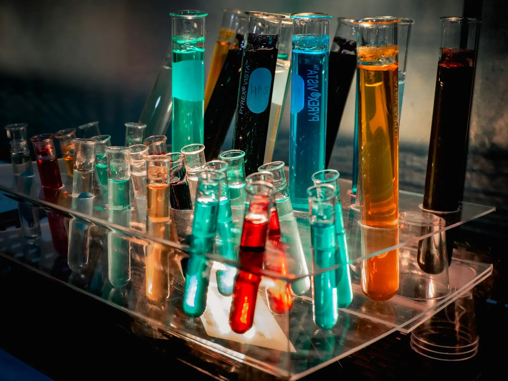 a bunch of test tubes filled with different colored liquids