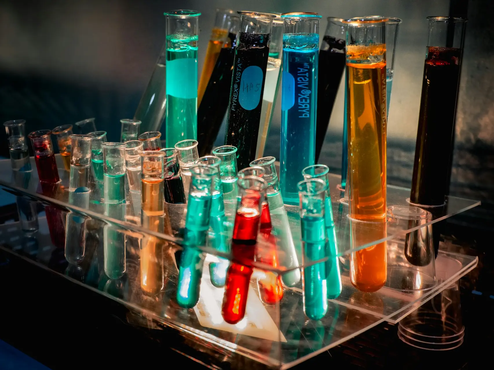 a bunch of test tubes filled with different colored liquids